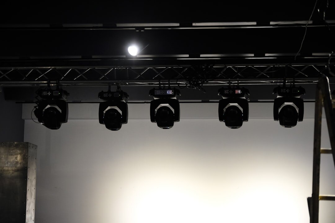 Studio lighting rig with softboxes and moving head lights above a set