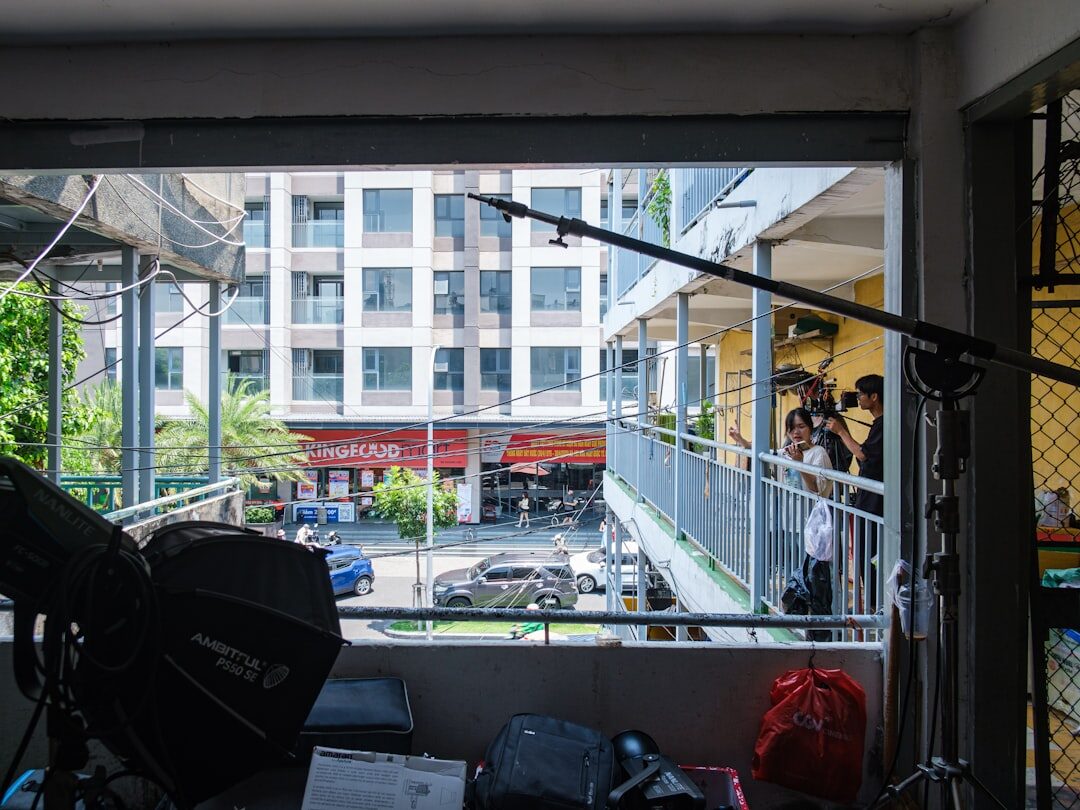 Wide view of a television news studio set with lighting rig and news desk