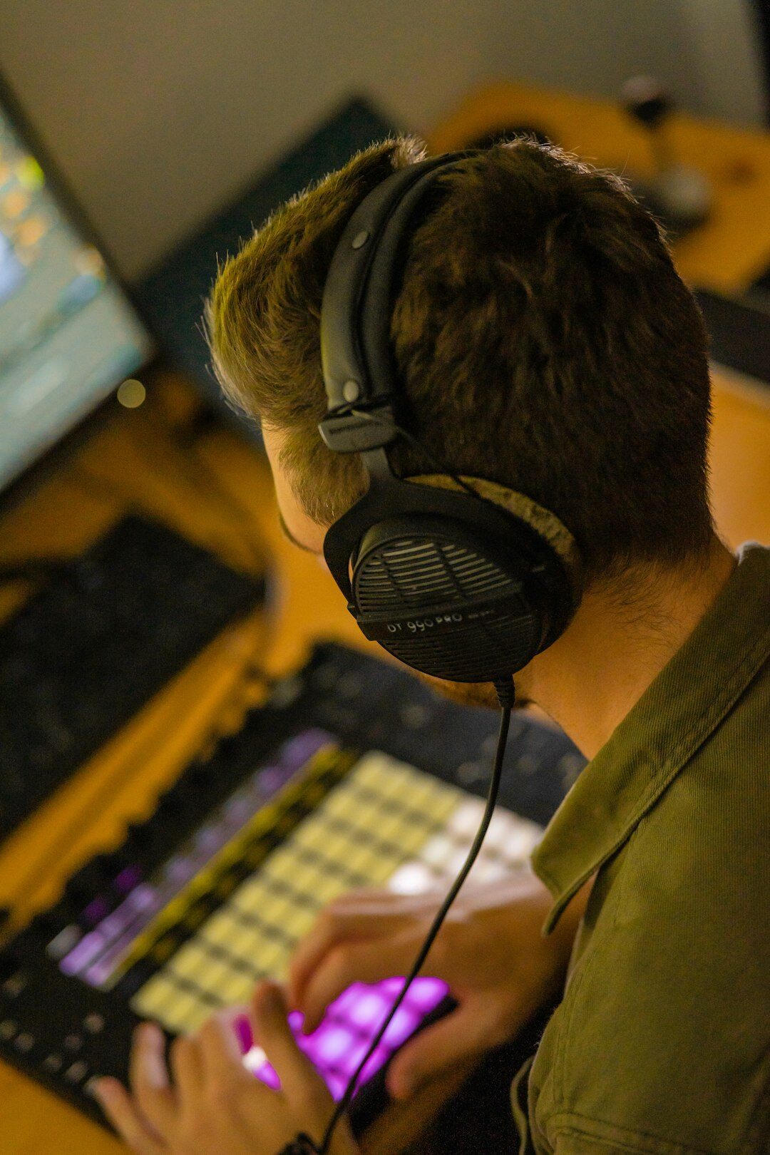 Sound engineer working at an audio mixing console with headphones