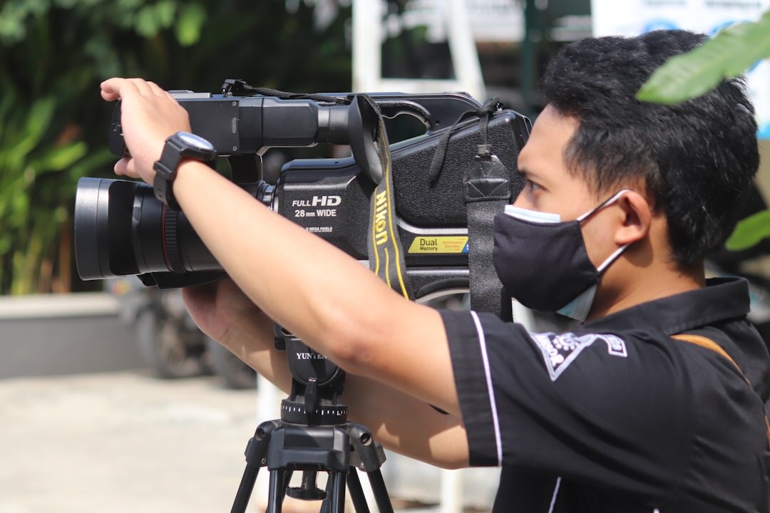 Camera operator holding a professional broadcast camera on his shoulder