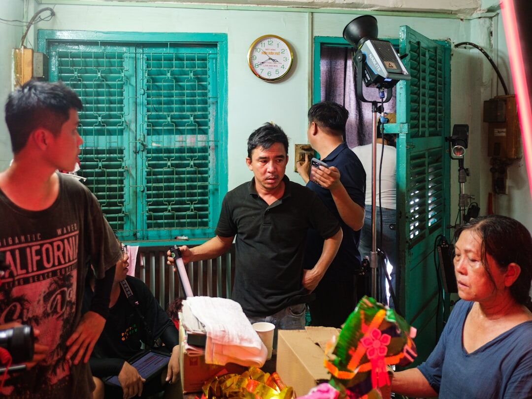Team of studio production professionals standing together in a television studio